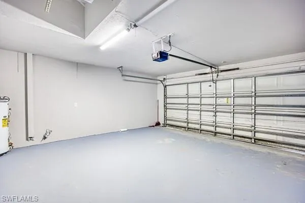 Garage with water heater and a garage door opener