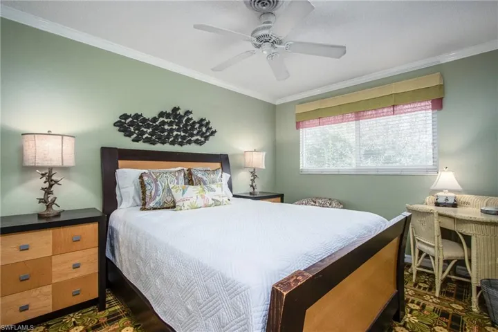 Bedroom with ornamental molding and ceiling fan