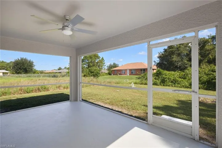 Unfurnished sunroom with a healthy amount of sunlight and ceiling fan
