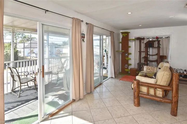 Doorway to outside featuring tile patterned floors and recessed lighting