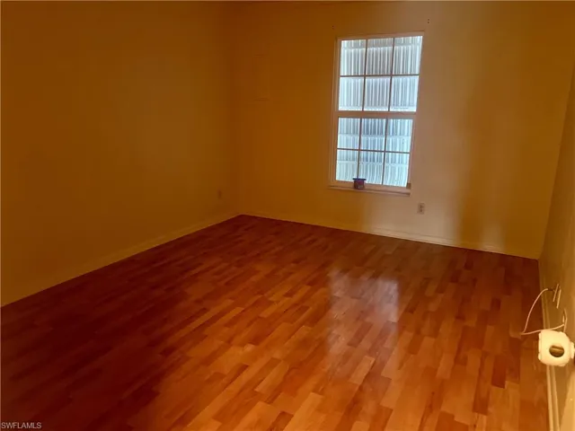 Master bedroom with wood-type flooring