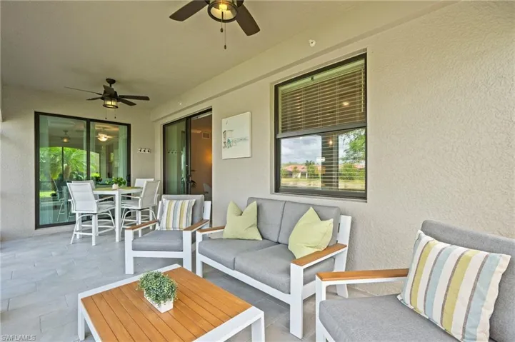 View of patio / terrace featuring an outdoor living space, outdoor dining space, and a ceiling fan