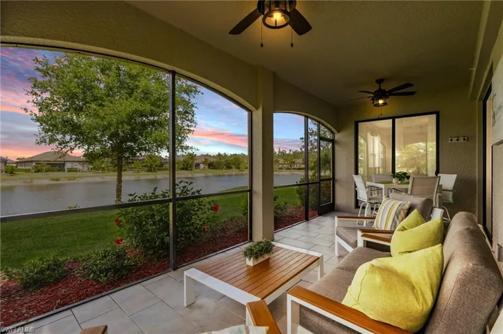 Sunroom / solarium featuring outdoor lounge area, tile patterned floors, a water view, and a ceiling fan