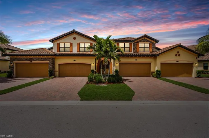 Mediterranean / spanish-style house featuring a tile roof, decorative driveway, and stucco siding