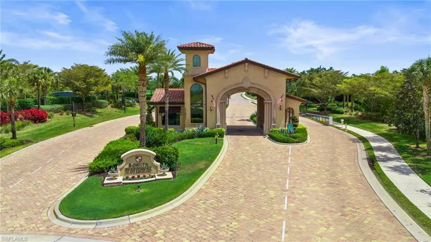 View of property's community featuring a yard and curved driveway