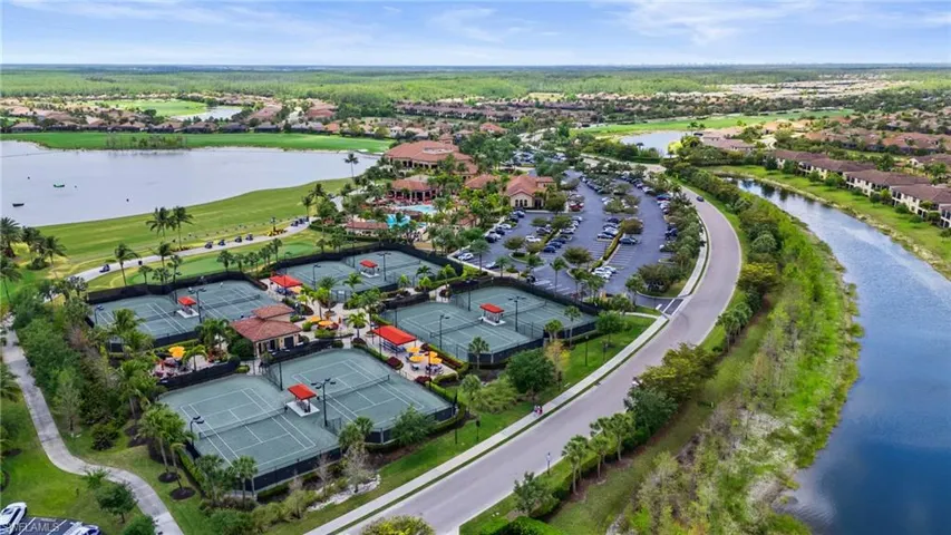 Aerial view with view of golf course and a water view