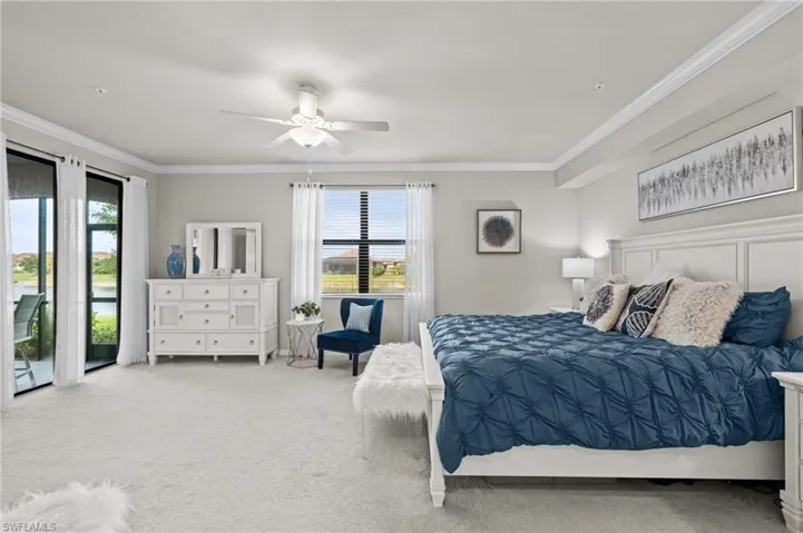Carpeted bedroom featuring access to exterior, ceiling fan, and crown molding