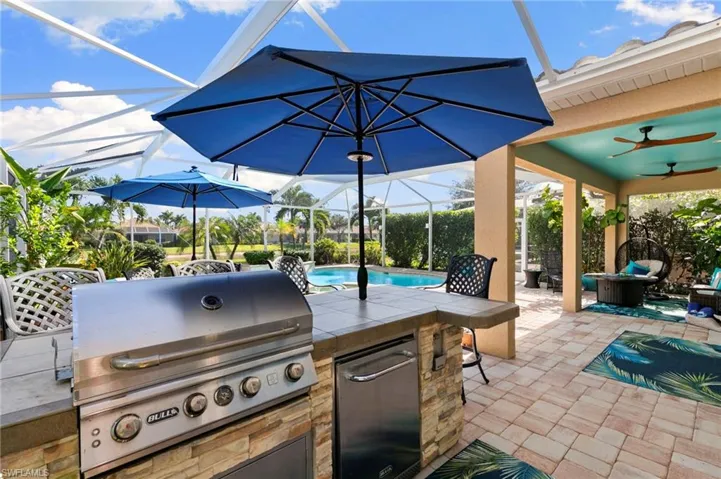 View of patio with a lanai, ceiling fan, a sunroom, and an outdoor pool