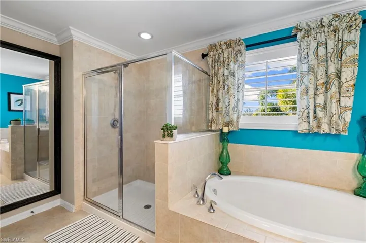 Bathroom with a bath, crown molding, a shower stall, recessed lighting, and tile patterned flooring
