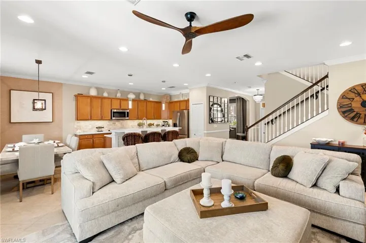 Living area featuring crown molding, a ceiling fan, recessed lighting, stairway, and light tile patterned floors