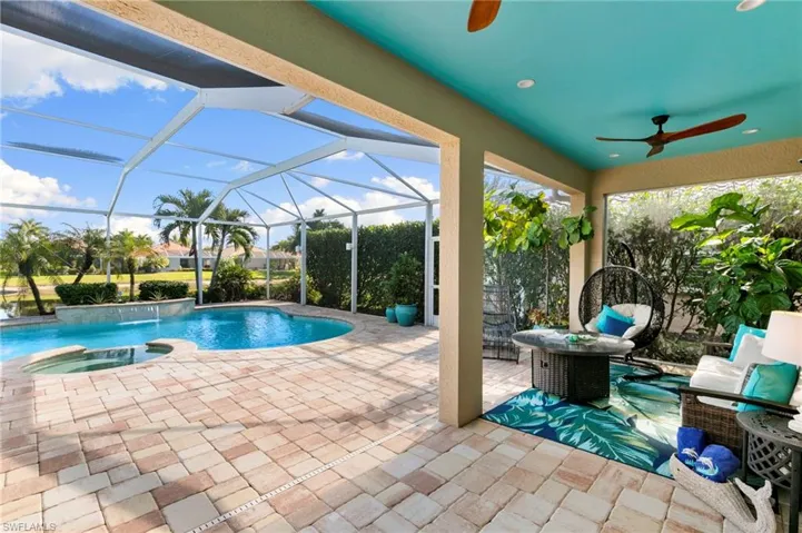 View of pool with a patio area, a pool with connected hot tub, a sunroom, and a lanai