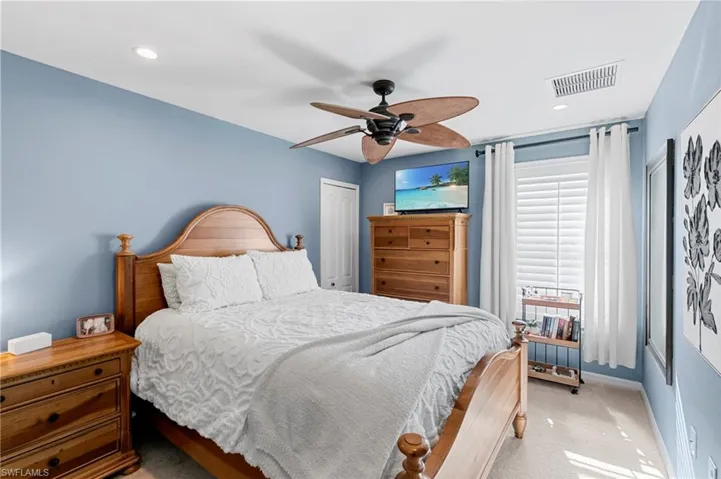 Bedroom with carpet, a closet, ceiling fan, and recessed lighting