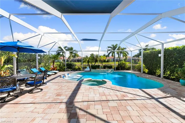 View of swimming pool with a pool with connected hot tub, a sunroom, a lanai, and a patio area