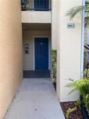 Entrance to property featuring stucco siding