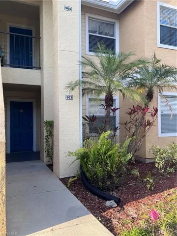 Entrance to property with stucco siding