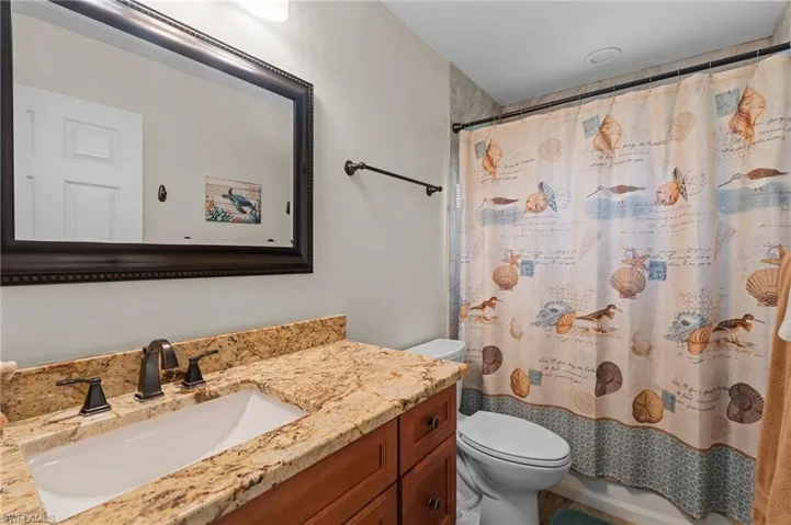 Guest Bathroom with Granite Countertop & Tub/Shower Combination