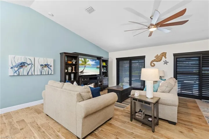 The Living Room has Sliders with Beautiful Plantation Shutters to the Lanai