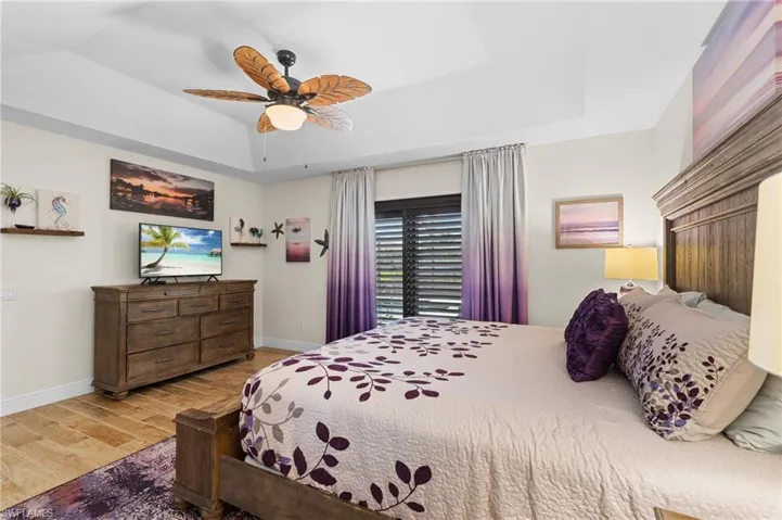 Primary Bedroom has Slider with Plantation Shutters to the Lanai