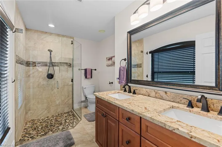 En Suite Bathroom in Primary Bedroom with Granite Countertops