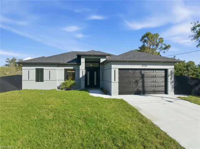 Prairie-style home with stucco siding, concrete driveway, an attached garage, and a shingled roof
