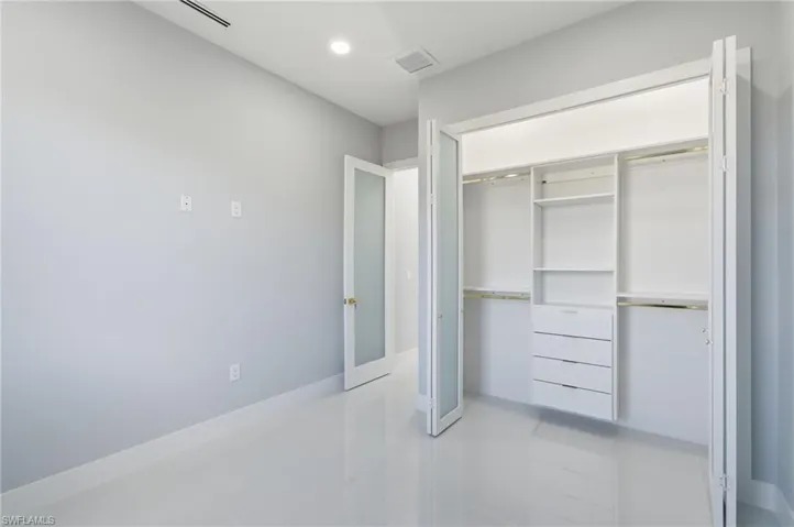 Unfurnished bedroom with recessed lighting and a closet