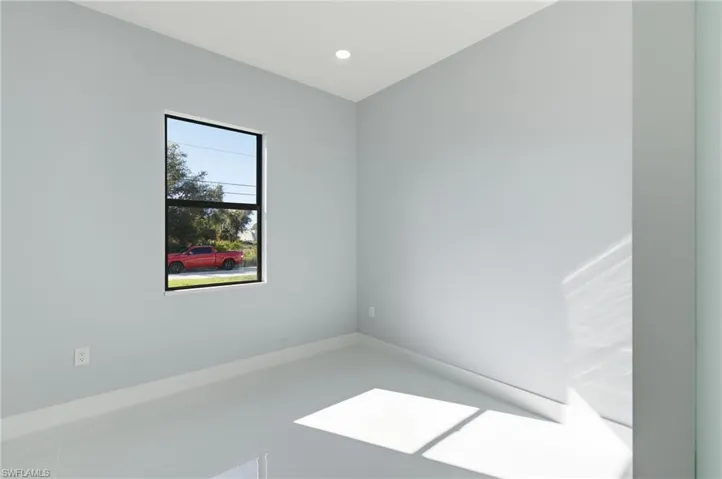 Spare room featuring baseboards and recessed lighting