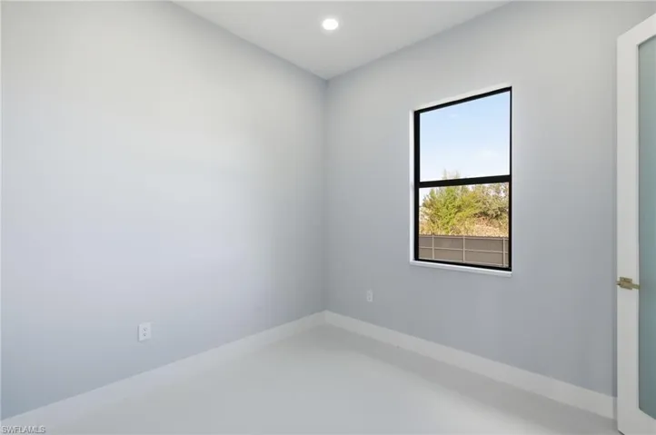 Spare room featuring recessed lighting and baseboards