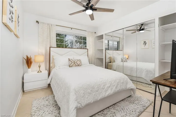 Bedroom with a ceiling fan and light tile patterned floors