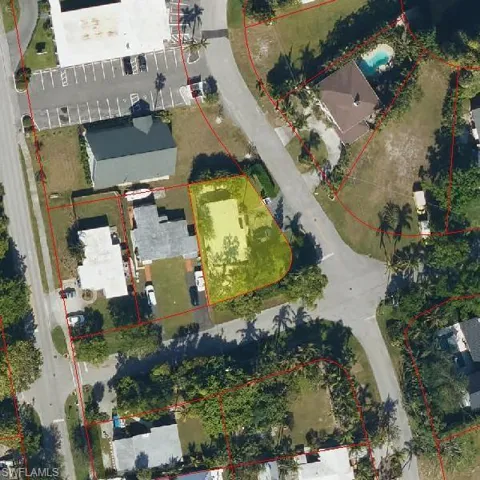 Aerial view of property and surrounding area featuring property boundaries highlighted
