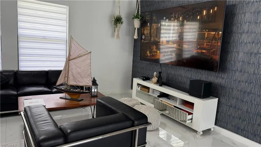 Living room with baseboards and marble finish flooring