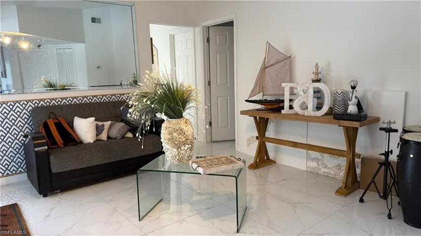 Living room featuring marble finish floors