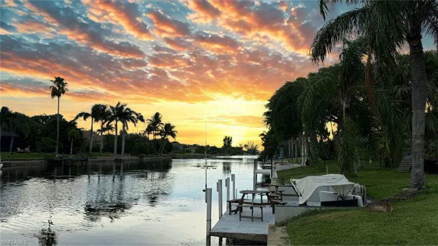 Dock featuring a water view and a lawn