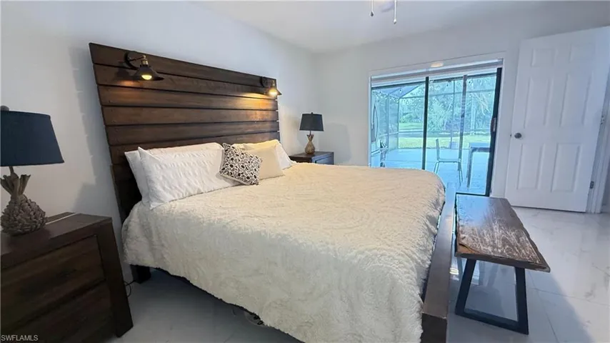 Bedroom with access to outside and marble look tiles