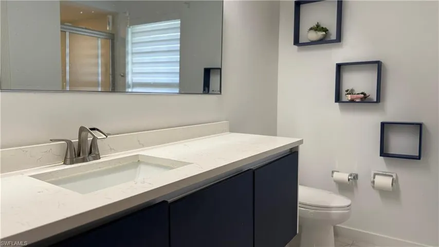 Bathroom featuring vanity and a shower with door