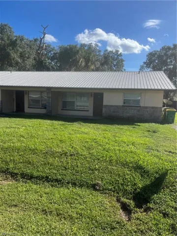 Single story home featuring a front lawn