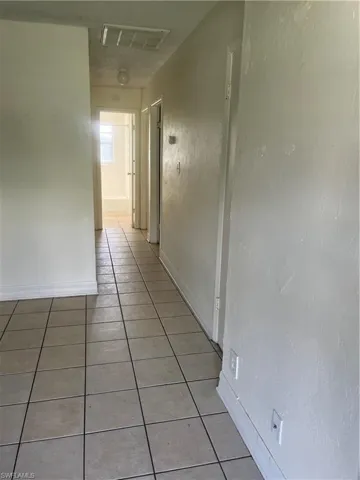 Corridor with light tile patterned floors