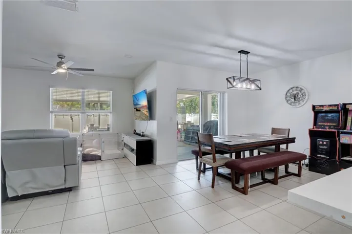 Dining room with light tile patterned floors and a ceiling fan