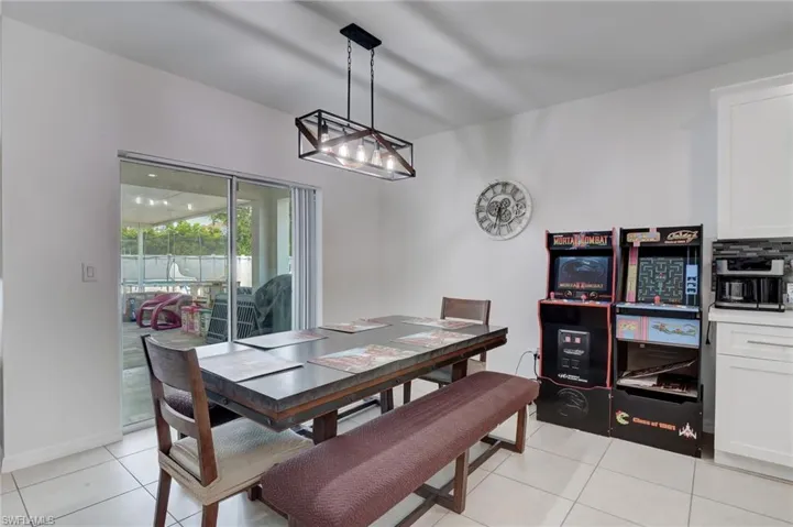 Dining area with light tile patterned flooring