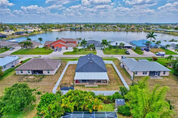 Aerial perspective of suburban area with a nearby body of water