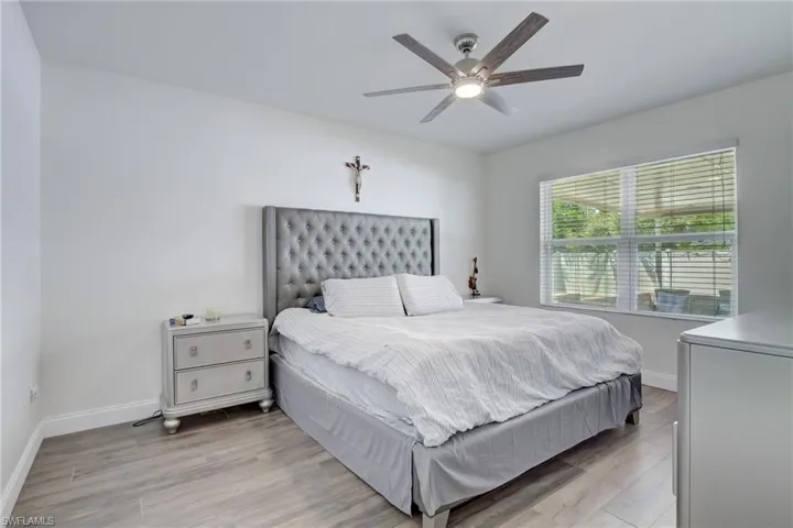 Bedroom featuring wood finished floors and a ceiling fan