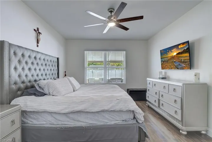 Bedroom featuring dark wood-type flooring and ceiling fan