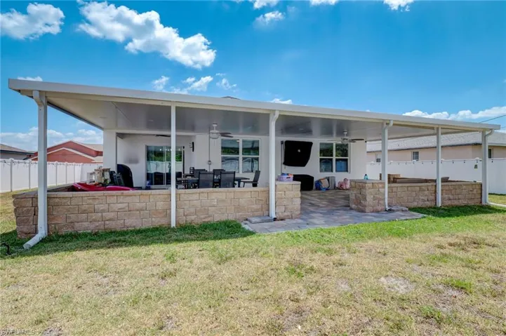 Back of house with a ceiling fan, a fenced backyard, and a patio