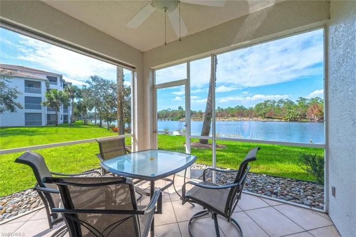 Sunroom with a water view and ceiling fan