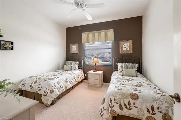 Carpeted bedroom featuring ceiling fan
