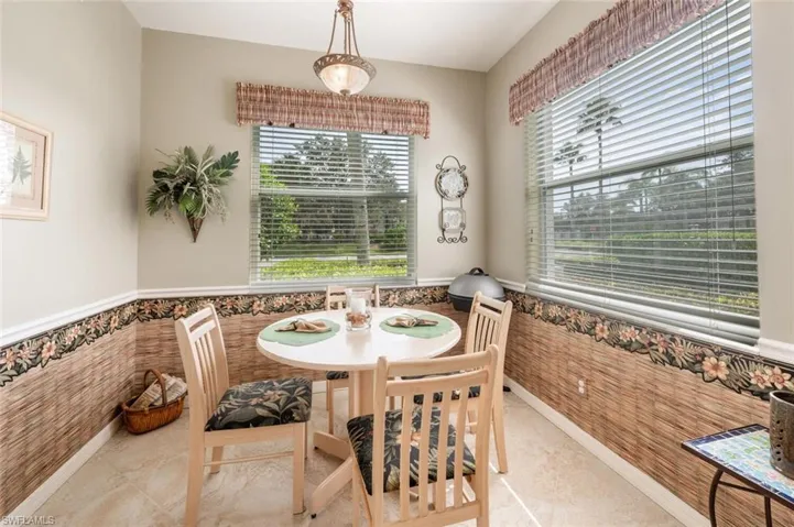 Dining space featuring tile walls, a healthy amount of sunlight, and light tile patterned floors