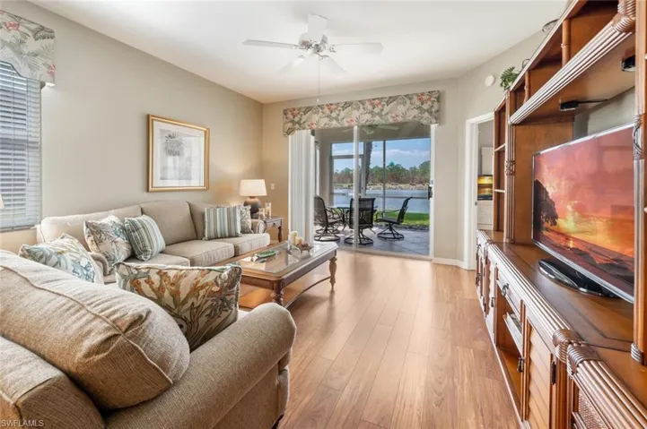 Living room featuring light wood-type flooring and ceiling fan