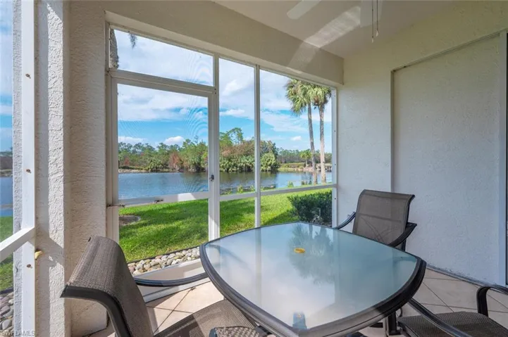 Sunroom featuring a water view
