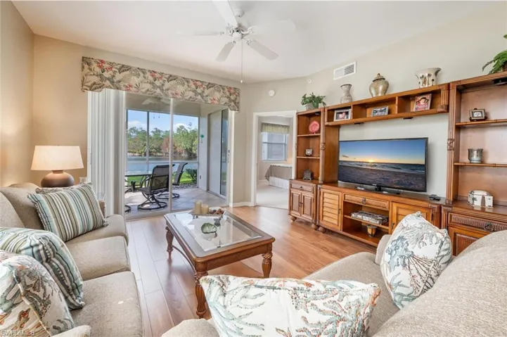 Living room featuring light wood-type flooring and ceiling fan