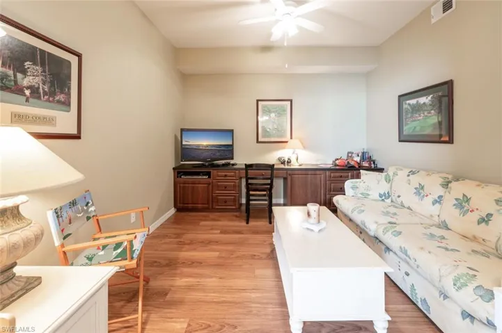 Living room with light hardwood / wood-style floors and ceiling fan