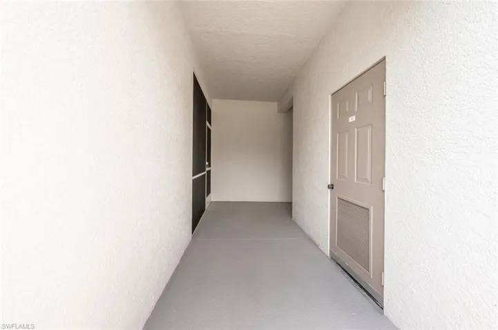 Corridor featuring a textured ceiling